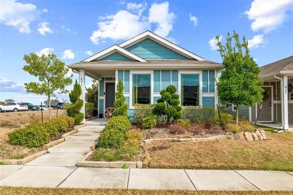 a living room with furniture and a kitchen