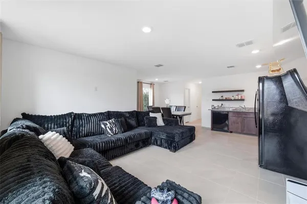 a kitchen with stainless steel appliances granite countertop a stove a sink dishwasher and a refrigerator with wooden cabinets