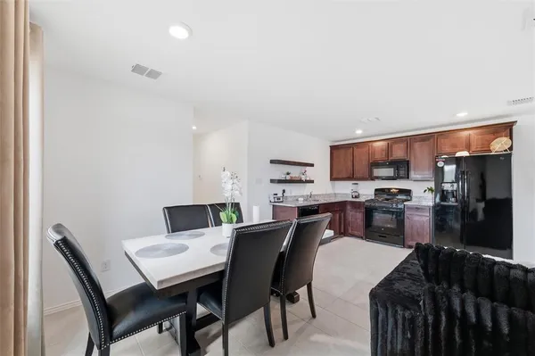a dining room with furniture and kitchen view