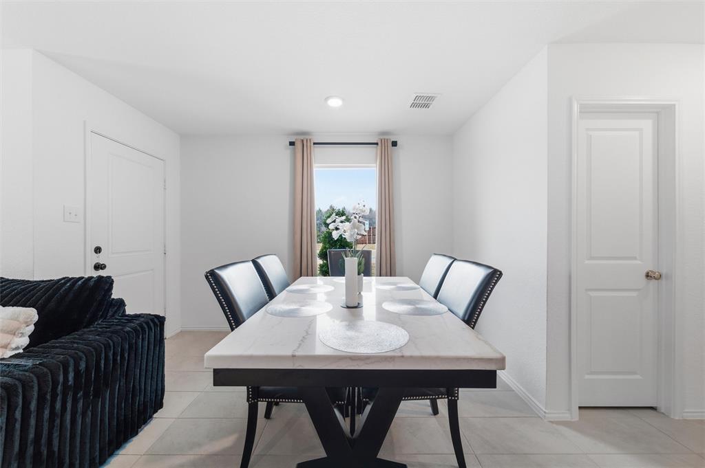 421 Corsair Way Ferris, TX 75125 - Photo 8 of 34 Dining area featuring baseboards and light tile patterned floors