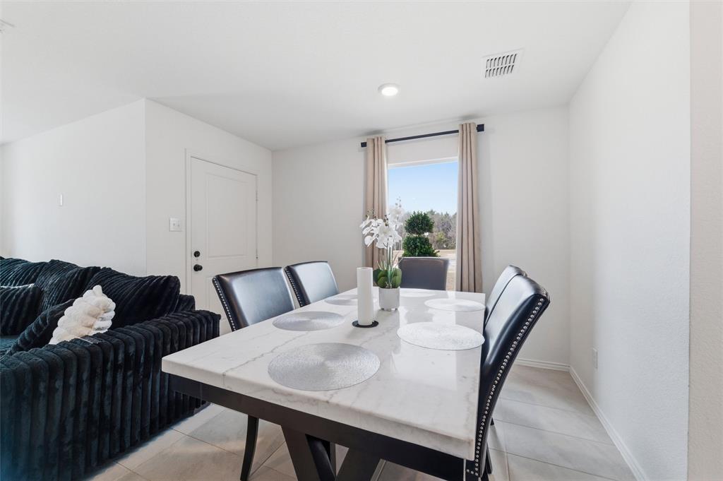 421 Corsair Way Ferris, TX 75125 - Photo 10 of 34 Dining space featuring baseboards and light tile patterned floors