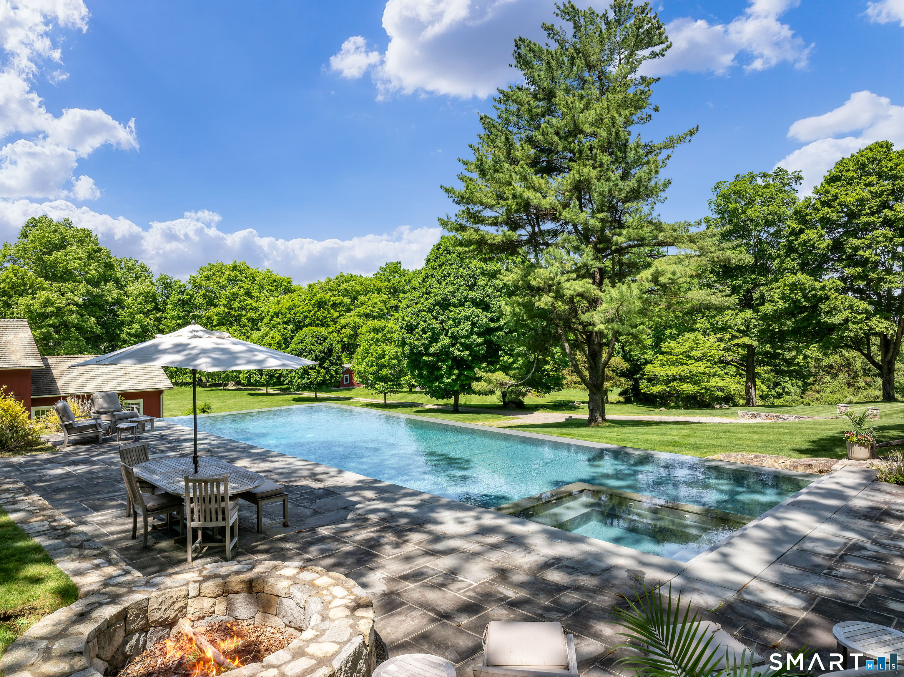 240 Umpawaug Road Redding, CT 06896 - Photo 7 of 40 The view from the pool of the lush, mature, verdant landscape.