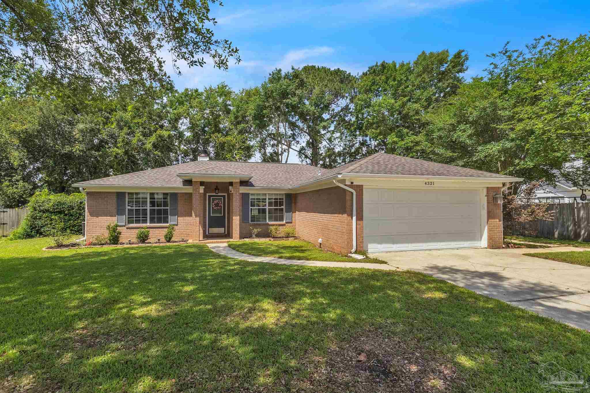 4321 Ridgeland Drive Pace, FL 32571 - Photo 27 of 36 a front view of a house with a garden