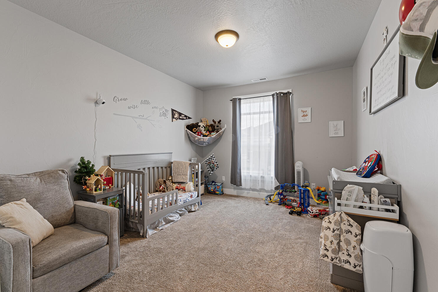 1043 Arrowhead Trail Eagle Point, OR 97524 - Photo 22 of 29 a living room with furniture a baby crib and a couch