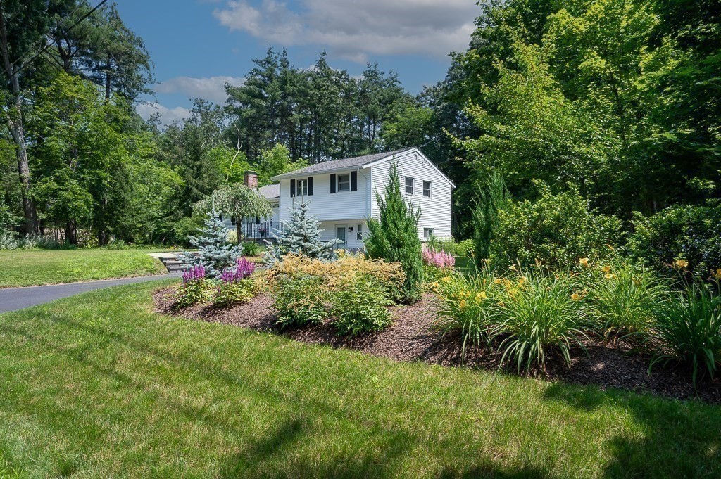 12 Sycamore Road Sudbury, MA 01776 - Photo 1 of 38 a front view of a house with a yard and fountain