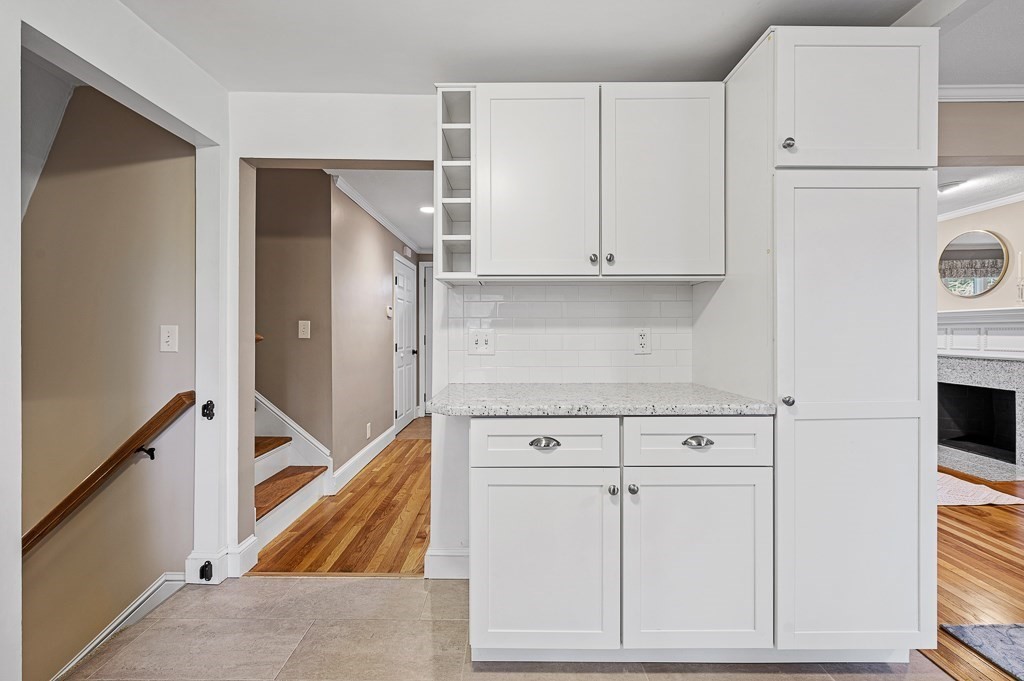 12 Sycamore Road Sudbury, MA 01776 - Photo 12 of 38 a kitchen with white cabinets and white appliances