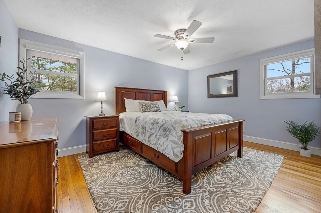 12 Sycamore Road Sudbury, MA 01776 - Photo 15 of 38 a bedroom with a bed and a chandelier