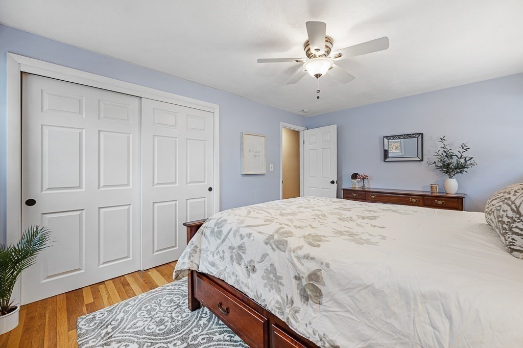 12 Sycamore Road Sudbury, MA 01776 - Photo 16 of 38 a spacious bedroom with a bed and a chandelier