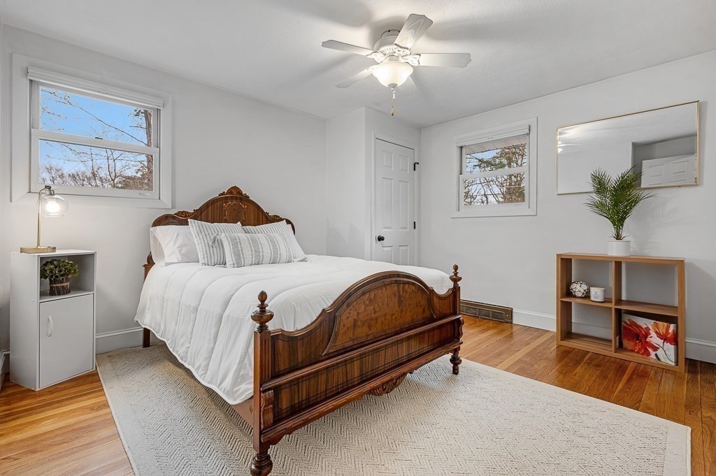 12 Sycamore Road Sudbury, MA 01776 - Photo 17 of 38 a bedroom with a bed and a chandelier
