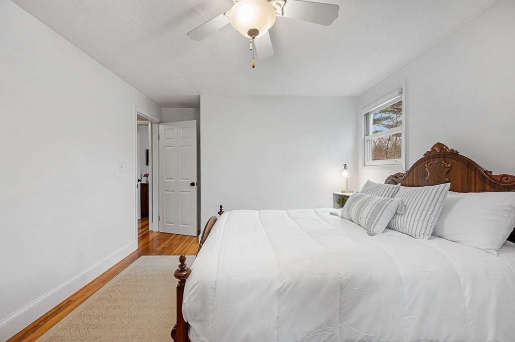 12 Sycamore Road Sudbury, MA 01776 - Photo 18 of 38 a bedroom with a bed and a chandelier