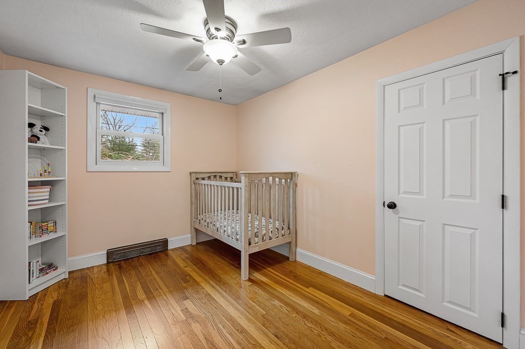 12 Sycamore Road Sudbury, MA 01776 - Photo 19 of 38 wooden floor in an empty room with a window