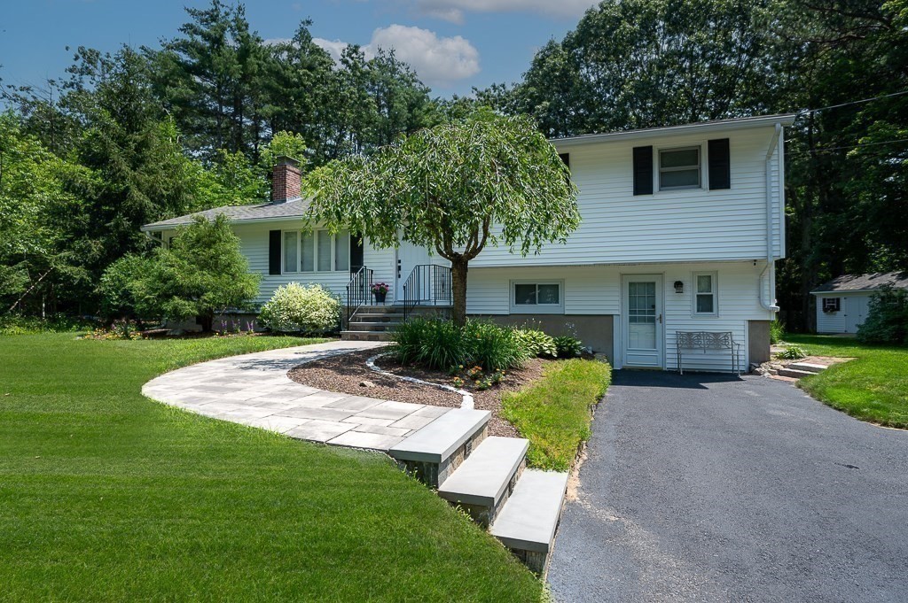 12 Sycamore Road Sudbury, MA 01776 - Photo 2 of 38 a front view of a house with garden and yard