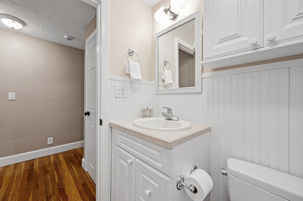 12 Sycamore Road Sudbury, MA 01776 - Photo 21 of 38 a bathroom with a sink a toilet a vanity and mirror