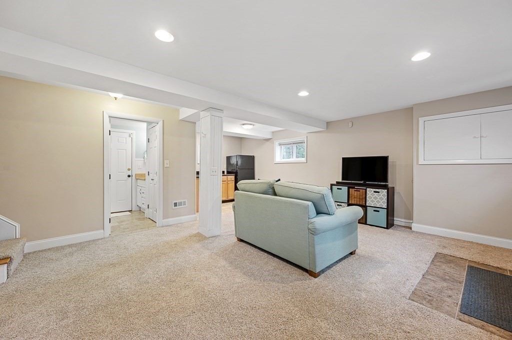 12 Sycamore Road Sudbury, MA 01776 - Photo 23 of 38 a living room with furniture and a flat screen tv