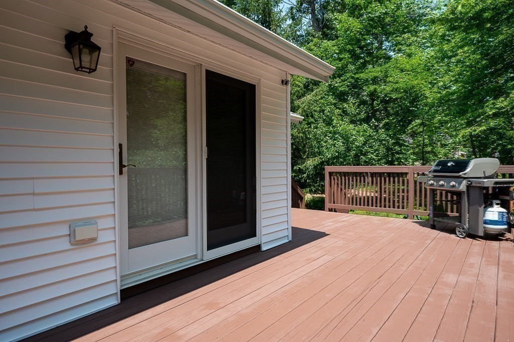 12 Sycamore Road Sudbury, MA 01776 - Photo 29 of 38 a view of a house with a barbeque and wooden stairs
