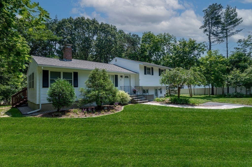 12 Sycamore Road Sudbury, MA 01776 - Photo 3 of 38 a front view of a house with a yard and green space
