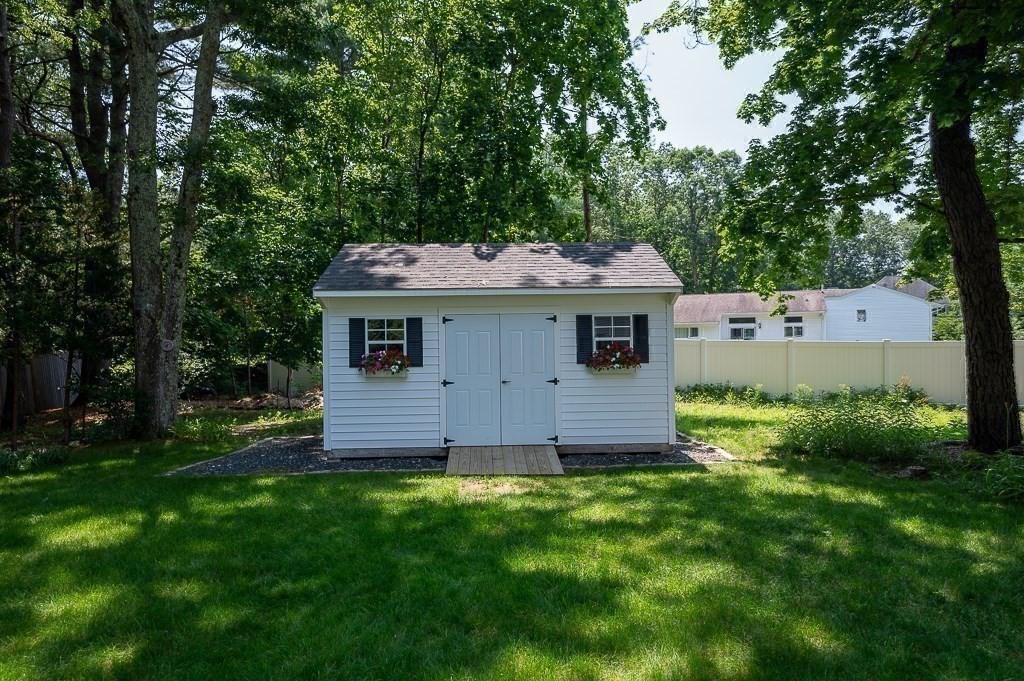 12 Sycamore Road Sudbury, MA 01776 - Photo 31 of 38 a view of a yard in front of a house with plants and large tree