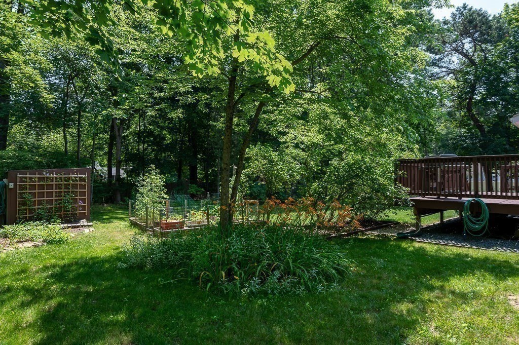 12 Sycamore Road Sudbury, MA 01776 - Photo 34 of 38 a view of backyard with table and chairs and wooden fence