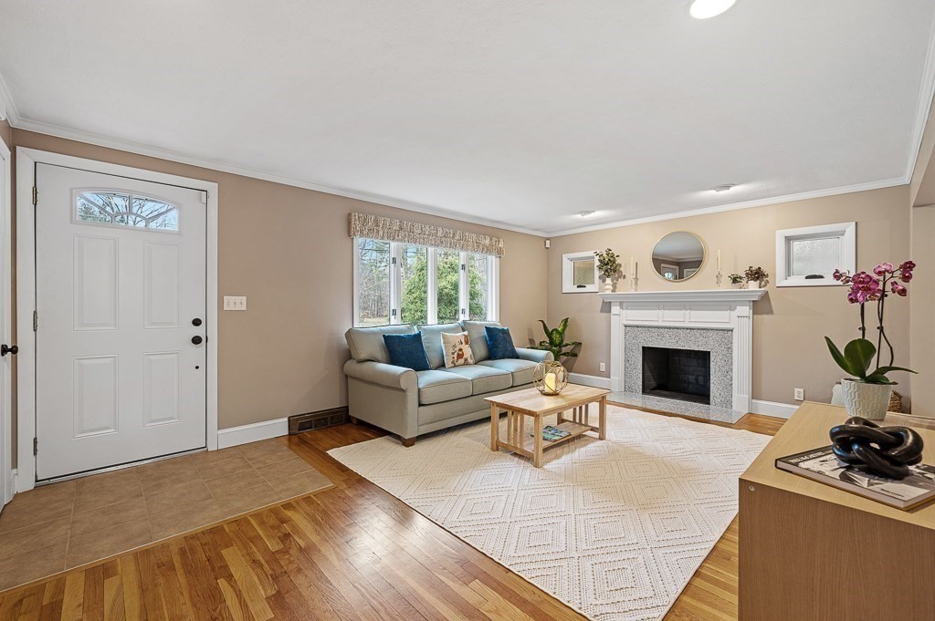12 Sycamore Road Sudbury, MA 01776 - Photo 5 of 38 a living room with furniture and a fireplace