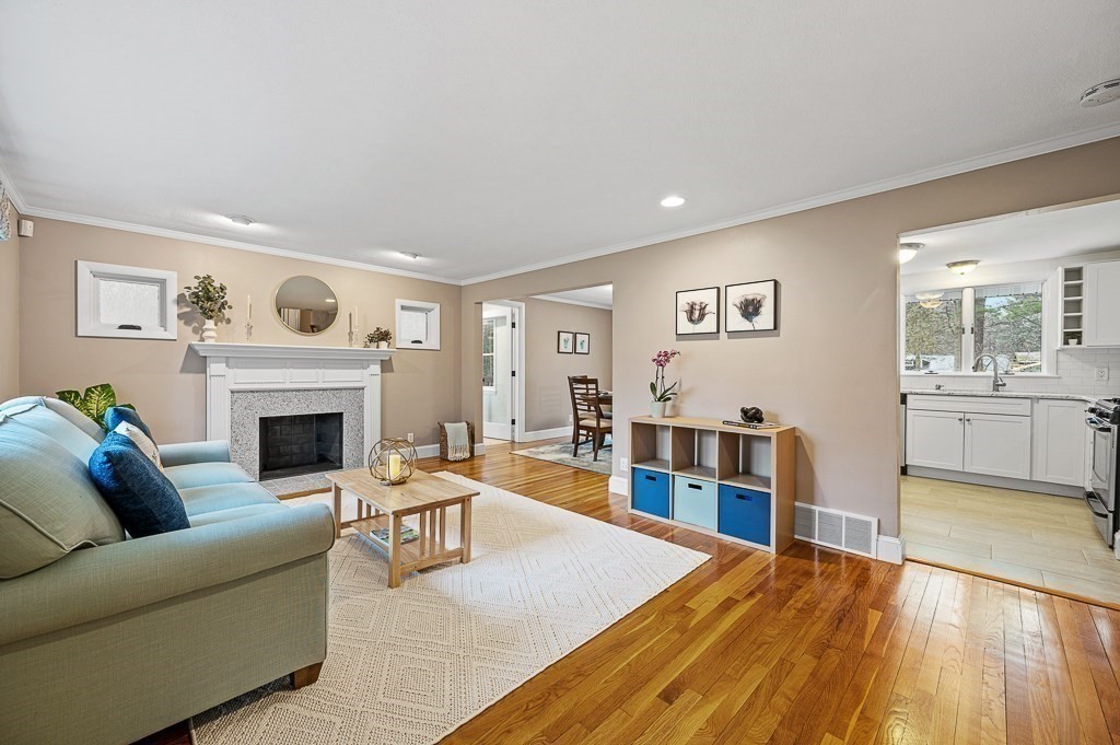 12 Sycamore Road Sudbury, MA 01776 - Photo 6 of 38 a living room with furniture and a fireplace