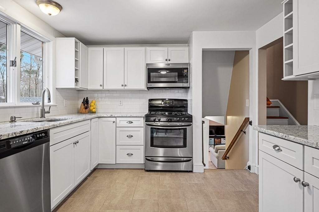 12 Sycamore Road Sudbury, MA 01776 - Photo 10 of 38 a kitchen with granite countertop a refrigerator stove and sink