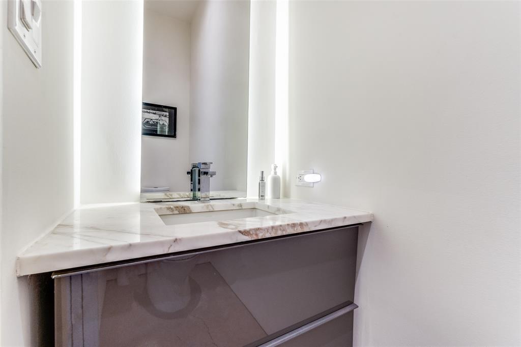 5804 Bryan Parkway Dallas, TX 75206 - Photo 14 of 25 a bathroom with a sink and a mirror