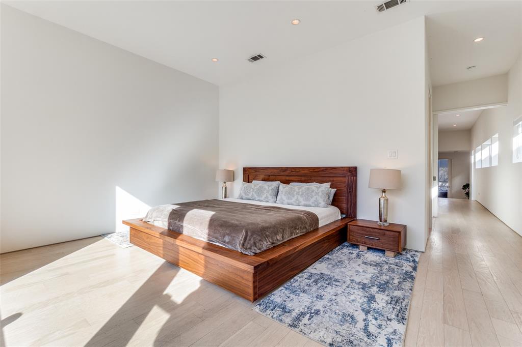 5804 Bryan Parkway Dallas, TX 75206 - Photo 16 of 25 a bedroom with a bed and wooden floor