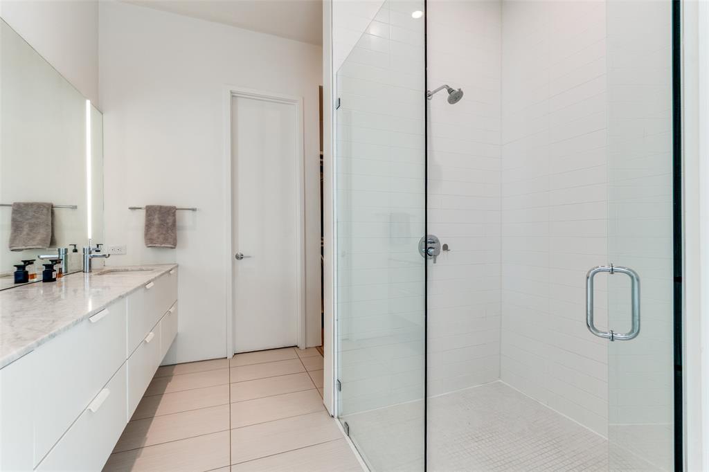 5804 Bryan Parkway Dallas, TX 75206 - Photo 18 of 25 a bathroom with a granite countertop sink a mirror and shower