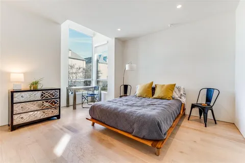 a bedroom with a bed a table and chair