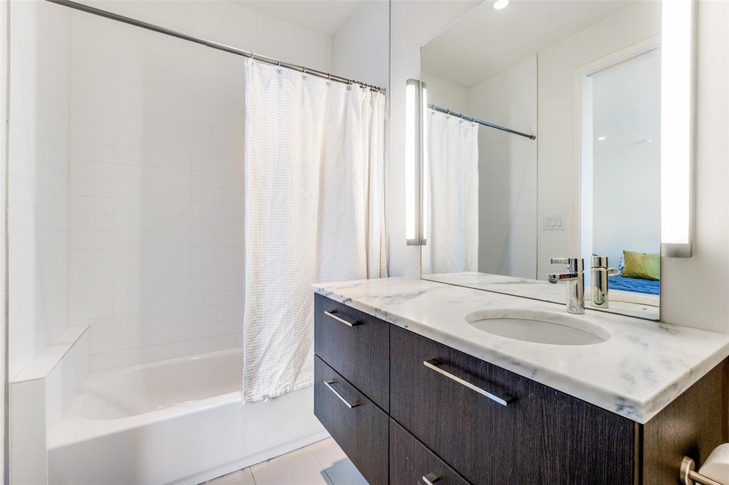 5804 Bryan Parkway Dallas, TX 75206 - Photo 22 of 25 a bathroom with a sink and a bathtub