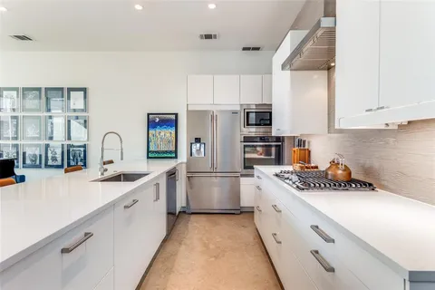 a kitchen with a sink a counter and stainless steel appliances