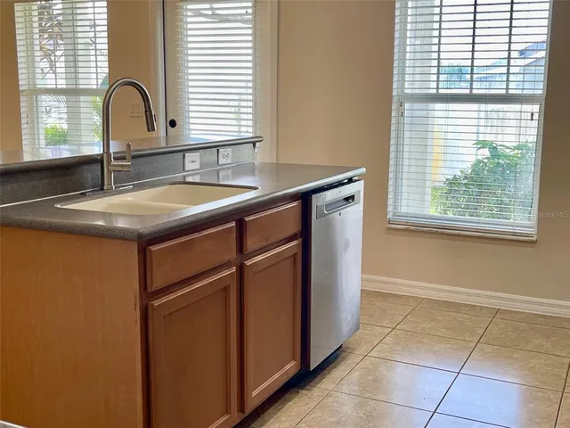 a kitchen with granite countertop a sink and a window