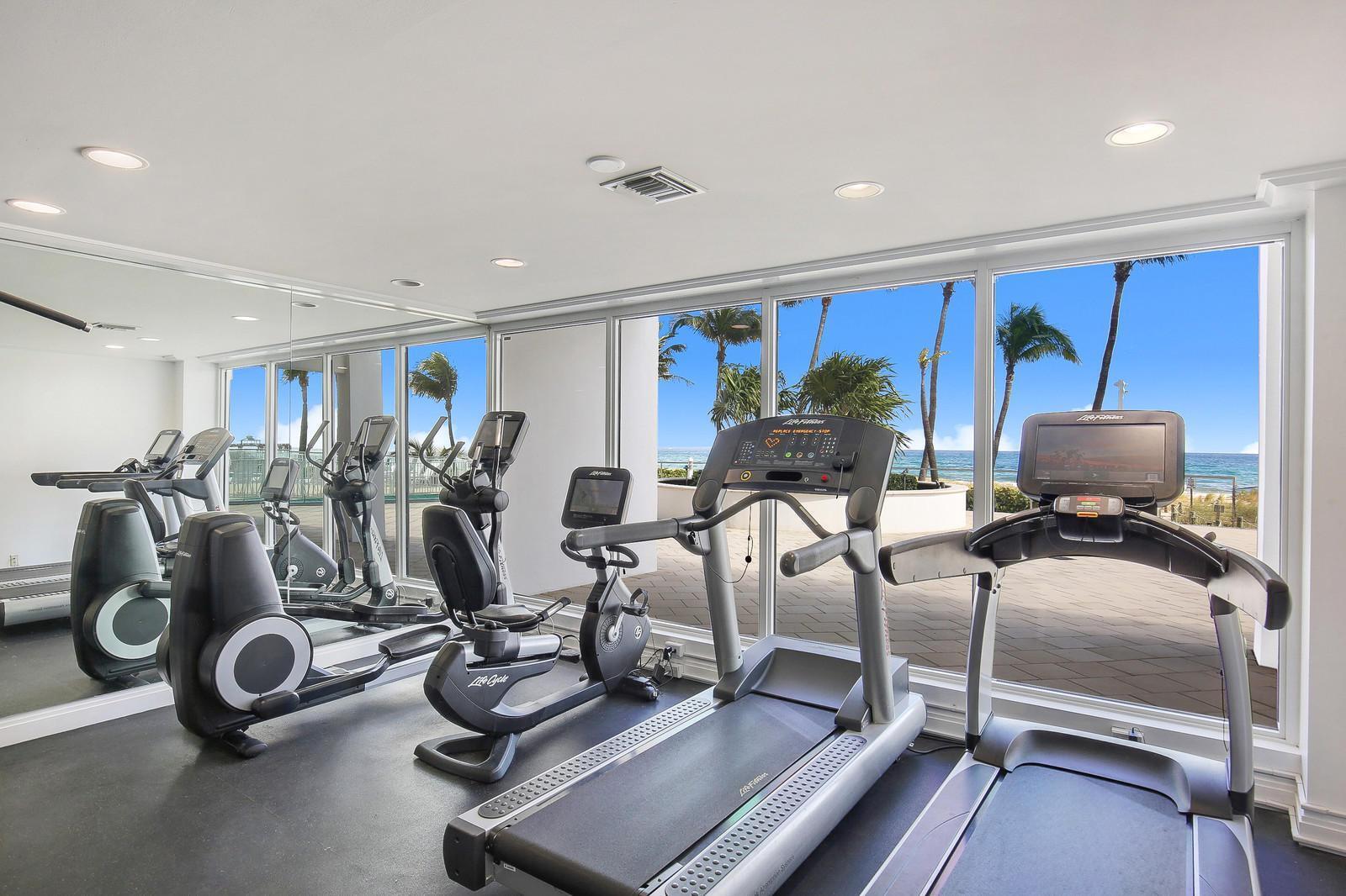 3000 South Ocean Boulevard, Unit 304 Boca Raton, FL 33432 - Photo 29 of 41 a room with gym equipment and large mirror