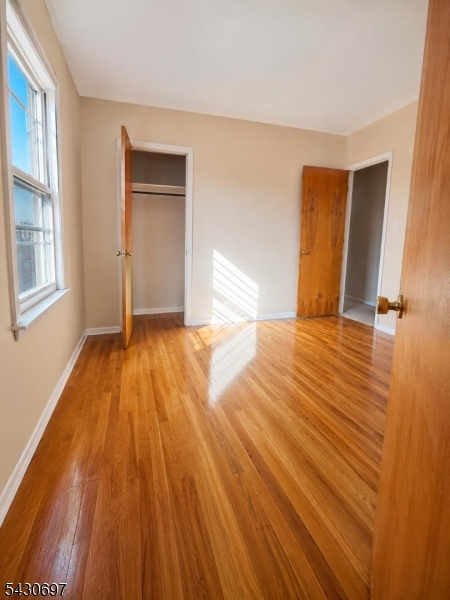 2479 Dayton Avenue Union, NJ 07083 - Photo 8 of 9 a view of an empty room with wooden floor and a window