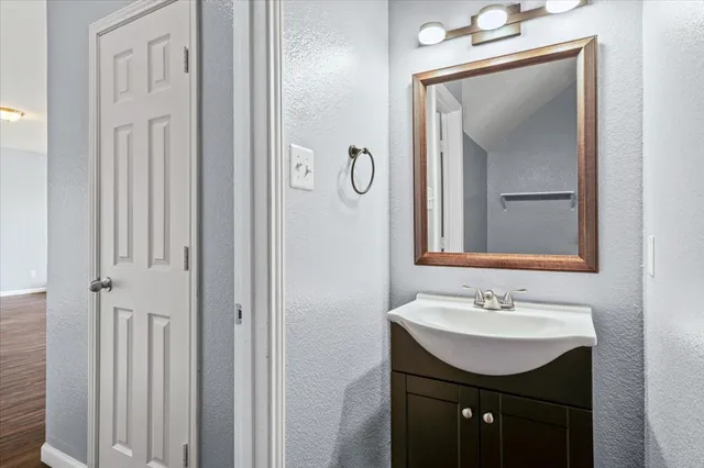 a bathroom with a sink vanity and a mirror