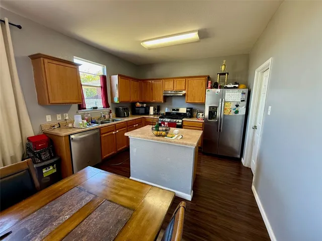 a kitchen with a sink appliances and cabinets