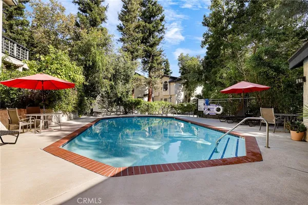 an outdoor space with swimming pool and furniture
