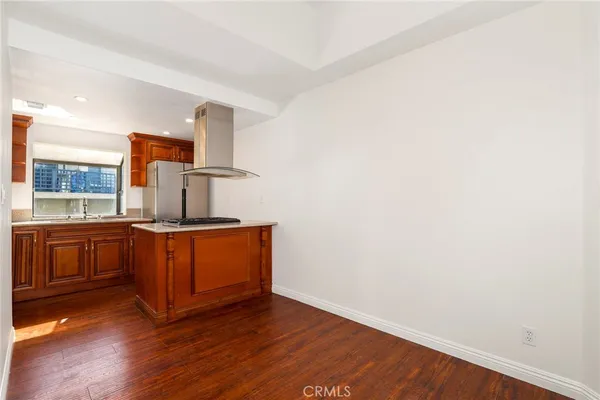 a kitchen with stainless steel appliances granite countertop a sink and wooden floor
