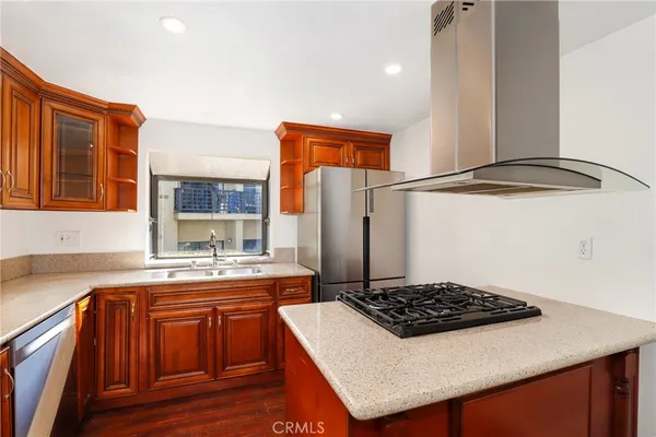 a kitchen with a sink a stove and a refrigerator