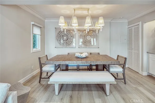 a view of a dining room with furniture wooden floor and chandelier