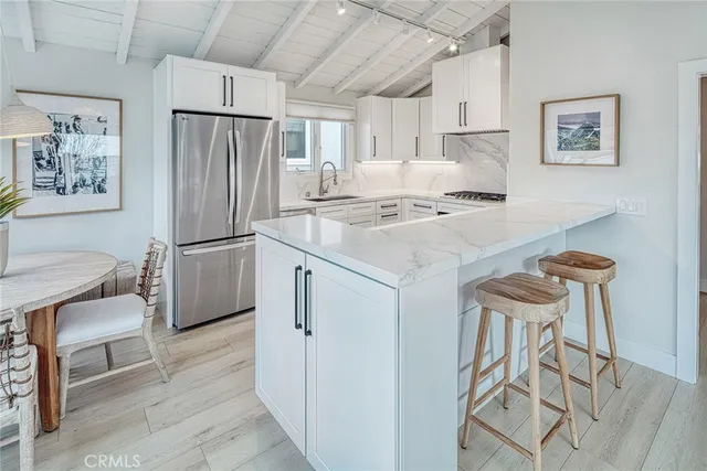 a kitchen with stainless steel appliances a refrigerator and a stove