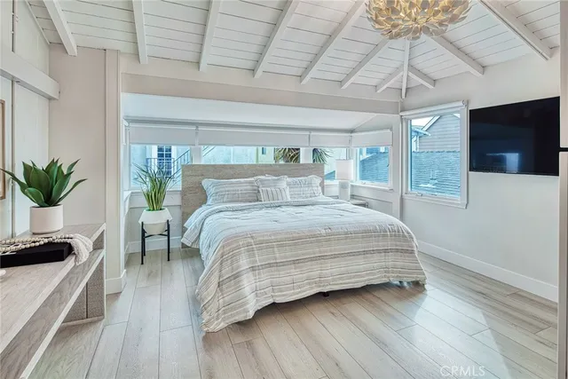 a bedroom with a large bed and a tv