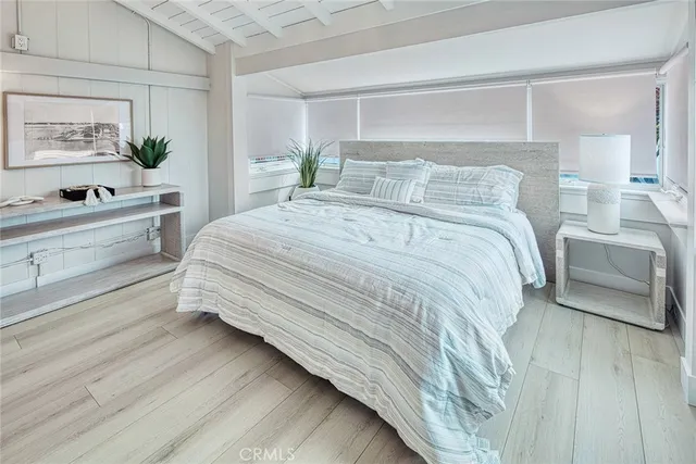 a bedroom with a bed and a night stand