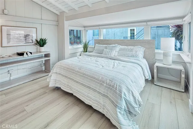a spacious bedroom with a bed and a large window