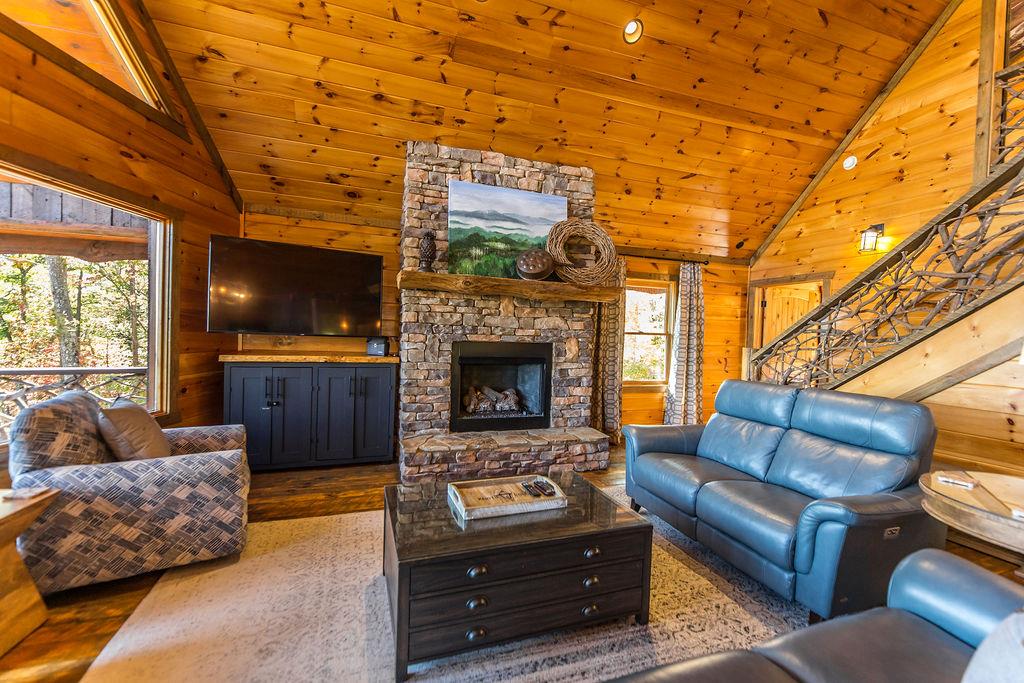 576 Century Blue Ridge Blue Ridge, GA 30513 - Photo 14 of 71 a living room with furniture a flat screen tv and a fireplace