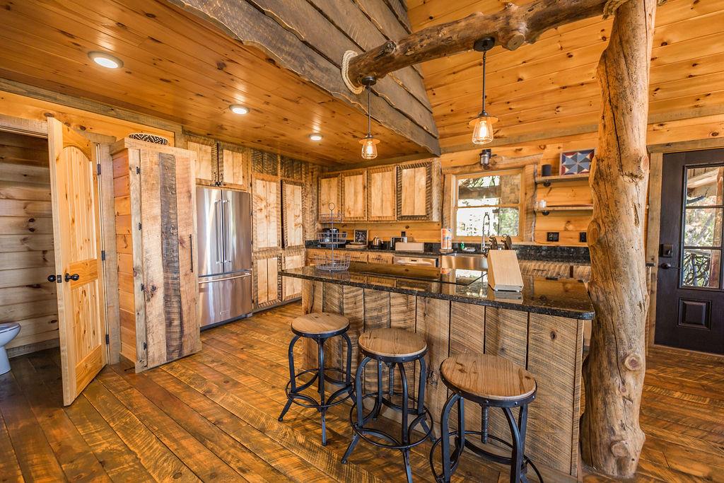 576 Century Blue Ridge Blue Ridge, GA 30513 - Photo 17 of 71 a kitchen with stainless steel appliances granite countertop a table chairs and a refrigerator