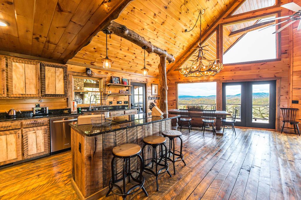 576 Century Blue Ridge Blue Ridge, GA 30513 - Photo 19 of 71 a kitchen with stainless steel appliances granite countertop table chairs and a stove