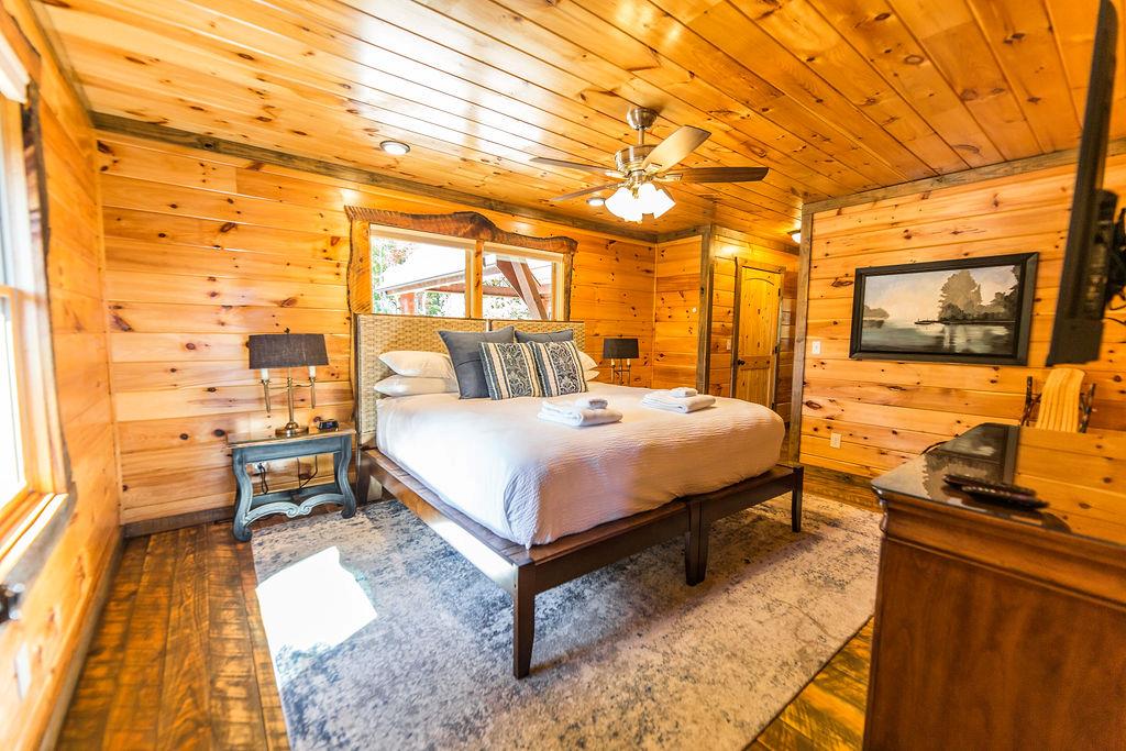 576 Century Blue Ridge Blue Ridge, GA 30513 - Photo 30 of 71 a bedroom with a bed and wooden floor
