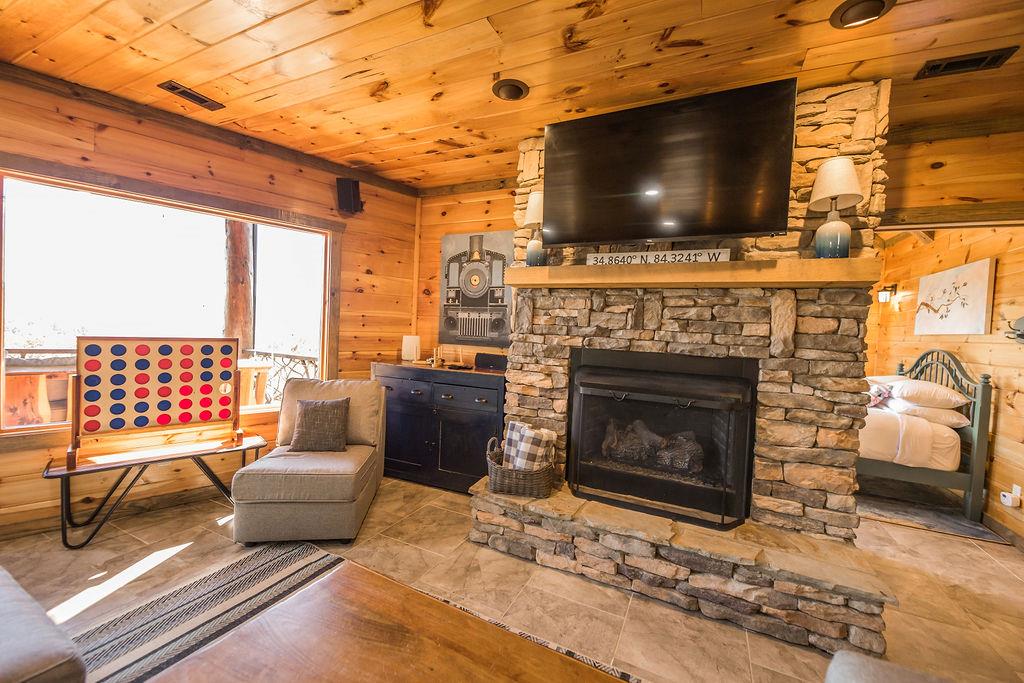 576 Century Blue Ridge Blue Ridge, GA 30513 - Photo 42 of 71 a living room with furniture a flat screen tv and a fireplace