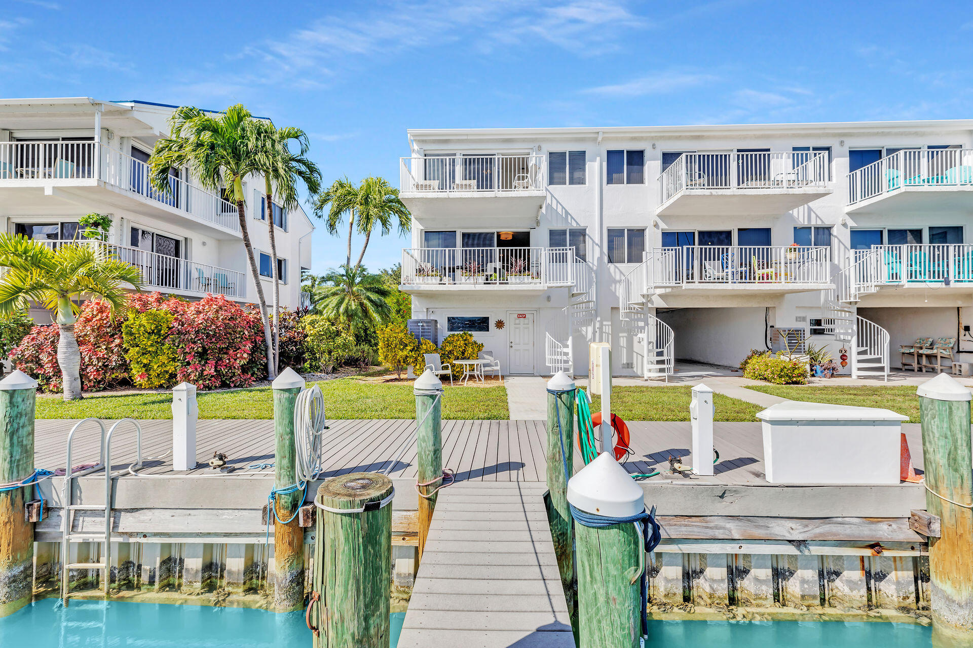 a view of a house with pool and chairs